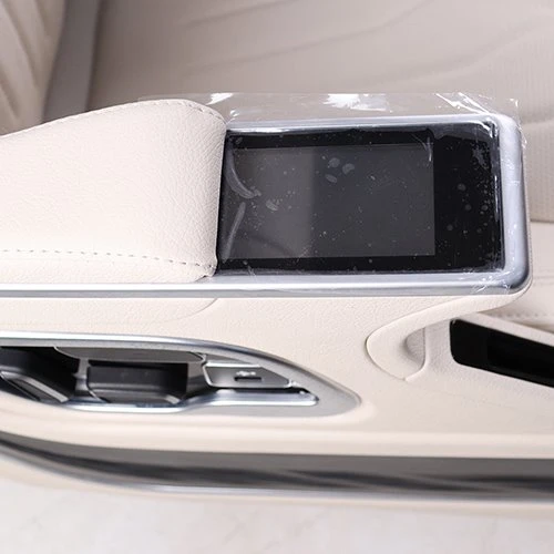 Touch control screen on the armrest of the van seat