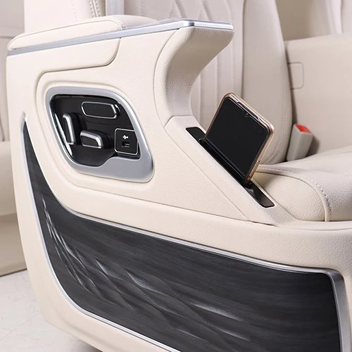 Phone storage box on van seat armrest